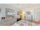 Bright bedroom featuring white walls, a large dresser with a mirror, and neutral carpeting at 8897 Midnight Pass Rd # 407, Sarasota, FL 34242