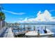Boat dock with boat slip, boat, bay view, and palm trees on a beautiful sunny day at 8897 Midnight Pass Rd # 407, Sarasota, FL 34242