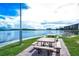 Scenic view of picnic tables and outdoor seating overlooking the water, with condominium buildings in the background at 8897 Midnight Pass Rd # 407, Sarasota, FL 34242