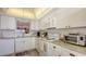 Well-lit kitchen with stainless steel appliances and plenty of cabinet space at 8897 Midnight Pass Rd # 407, Sarasota, FL 34242