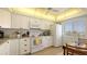 Charming kitchen with white cabinetry and a view of the ocean at 8897 Midnight Pass Rd # 407, Sarasota, FL 34242