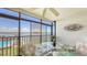 Charming dining space on the lanai with views of the pool and the sparkling Intracoastal waterway at 8897 Midnight Pass Rd # 407, Sarasota, FL 34242