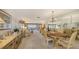 Spacious living and dining area featuring classic furnishings, a chandelier, and sliding doors to the lanai at 8897 Midnight Pass Rd # 407, Sarasota, FL 34242