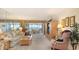 Cozy living room with plush seating and expansive windows offering scenic water views at 8897 Midnight Pass Rd # 407, Sarasota, FL 34242