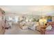 Open floor plan living area with a neutral color scheme, comfortable seating, and access to the lanai at 8897 Midnight Pass Rd # 407, Sarasota, FL 34242