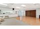 Spacious meeting room with tile and carpet flooring, kitchen access, and storage at 8897 Midnight Pass Rd # 407, Sarasota, FL 34242