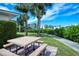 View of picnic tables on a grassy lawn, offering a peaceful outdoor space for residents at 8897 Midnight Pass Rd # 407, Sarasota, FL 34242