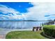 Scenic waterfront view with a bench to sit and enjoy the serene bay and endless docks on a sunny day at 8897 Midnight Pass Rd # 407, Sarasota, FL 34242