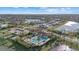 Aerial view of the community featuring a clubhouse, pool, and lake at 8982 Baroque Ter, Sarasota, FL 34240
