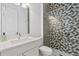 Bathroom with a glass-enclosed shower and geometrically patterned tile at 8982 Baroque Ter, Sarasota, FL 34240