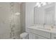 Modern bathroom with glass shower, tiled walls, and a white vanity at 8982 Baroque Ter, Sarasota, FL 34240
