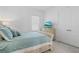 Bright bedroom with serene blue bedding, a TV, and a closet at 8982 Baroque Ter, Sarasota, FL 34240