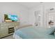 Bright bedroom featuring a dresser with TV and coastal-themed decor at 8982 Baroque Ter, Sarasota, FL 34240