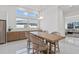 Bright dining area with a modern table, seating for four, and a view of the outdoors at 8982 Baroque Ter, Sarasota, FL 34240