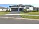 Charming one-story home with dark trim and a beautifully landscaped front yard and cobblestone driveway at 8982 Baroque Ter, Sarasota, FL 34240