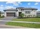 Beautiful single-Gathering home with a two-car garage, well-manicured lawn, and lush landscaping enhances curb appeal at 8982 Baroque Ter, Sarasota, FL 34240