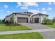 Attractive single-Gathering home with a three-car garage, well-manicured lawn, and lush landscaping enhance curb appeal at 8982 Baroque Ter, Sarasota, FL 34240
