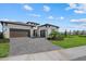 Elegant single-Gathering home with a three-car garage, well-manicured lawn, and lush landscaping enhance curb appeal at 8982 Baroque Ter, Sarasota, FL 34240