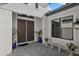 Elegant double front doors with transom window and tiled entry, complemented by lush potted plants at 8982 Baroque Ter, Sarasota, FL 34240