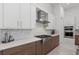 Modern kitchen features stainless steel appliances, white subway tile, and light countertops at 8982 Baroque Ter, Sarasota, FL 34240