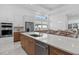 Spacious kitchen with a large center island, stainless steel appliances, and modern finishes at 8982 Baroque Ter, Sarasota, FL 34240