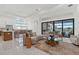 Open-concept living space with stylish furnishings, a modern kitchen, and sliding glass doors to outdoor living at 8982 Baroque Ter, Sarasota, FL 34240