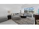 Spacious living room with oversized sectional, rug, and a view of the pool at 8982 Baroque Ter, Sarasota, FL 34240