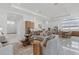Bright and spacious living area featuring a comfortable sofa, gourmet kitchen, and adjacent dining area at 8982 Baroque Ter, Sarasota, FL 34240