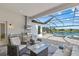Covered outdoor living space complete with grill, outdoor kitchen, and a pool view at 8982 Baroque Ter, Sarasota, FL 34240