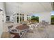 Community outdoor patio with comfortable seating arrangements, ceiling fans, and well-maintained landscaping at 8982 Baroque Ter, Sarasota, FL 34240