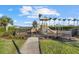 Community playground with lush landscaping and privacy fence at 8982 Baroque Ter, Sarasota, FL 34240