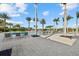 Spacious pool deck with lounge chairs, palm trees, and decorative stone landscaping at 8982 Baroque Ter, Sarasota, FL 34240