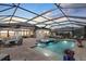 This screened-in pool area features a hot tub, plenty of seating, and an outdoor eating area at 8982 Baroque Ter, Sarasota, FL 34240