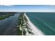 Stunning aerial shot captures waterfront houses nestled between the bay and the ocean at 951 Varet Rd, Venice, FL 34293