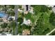 Aerial view showcases a backyard with a pool and solar panels in a residential neighborhood at 951 Varet Rd, Venice, FL 34293