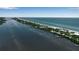 Breathtaking aerial view of waterfront homes lining the coast with docks on a sunny day at 951 Varet Rd, Venice, FL 34293