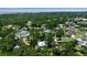 Aerial view of homes with lush green surroundings under a clear sky with ocean in the distance at 951 Varet Rd, Venice, FL 34293