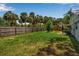 Expansive backyard offering ample room for outdoor living, framed by mature trees and fencing at 951 Varet Rd, Venice, FL 34293
