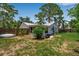 Private backyard featuring mature trees, fencing, green lawn and back of house in view at 951 Varet Rd, Venice, FL 34293