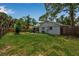Spacious, fully fenced backyard ideal for outdoor activities, featuring a green lawn and trees at 951 Varet Rd, Venice, FL 34293