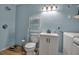 Cozy bathroom featuring a practical layout with a washing machine and storage rack system at 951 Varet Rd, Venice, FL 34293