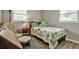 Bedroom with hardwood flooring, cozy bed, and a bright window at 951 Varet Rd, Venice, FL 34293