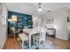 Spacious dining area with white table, bench, and blue accent wall adorned with decorative shelving at 951 Varet Rd, Venice, FL 34293