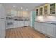 Well-lit kitchen with modern appliances, white cabinets, and stylish countertops, offering ample storage at 951 Varet Rd, Venice, FL 34293