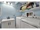Functional laundry room with modern washer and dryer, shelving for organized storage at 951 Varet Rd, Venice, FL 34293