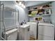 Efficient laundry area equipped with modern appliances and extra shelving for storage solutions at 951 Varet Rd, Venice, FL 34293