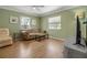Comfortable living room featuring hardwood floors, a plush sofa and two windows at 951 Varet Rd, Venice, FL 34293