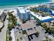 Aerial view of a beachside property, showcasing close proximity to sandy beach and nearby hotels at 1001 Point Of Rocks Rd # 207, Sarasota, FL 34242