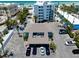 Unique aerial view of a two-story building with a courtyard, beach and ample parking at 1001 Point Of Rocks Rd # 207, Sarasota, FL 34242