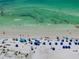 Beautiful beach scene with umbrellas and people enjoying a sunny day in the ocean at 1001 Point Of Rocks Rd # 207, Sarasota, FL 34242